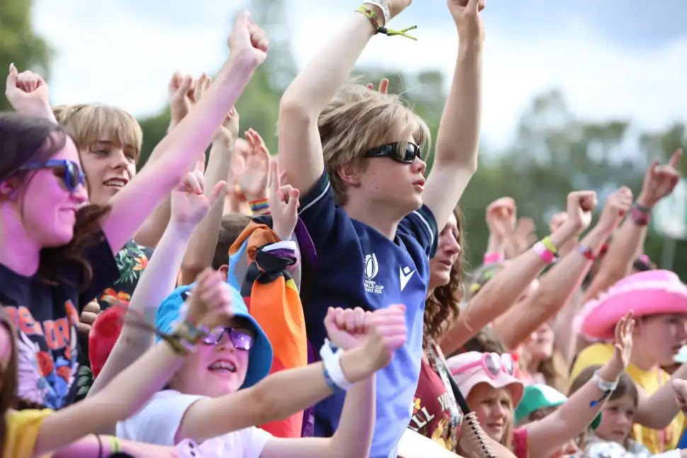 A close-up of a happy young crowd looking towards the stage