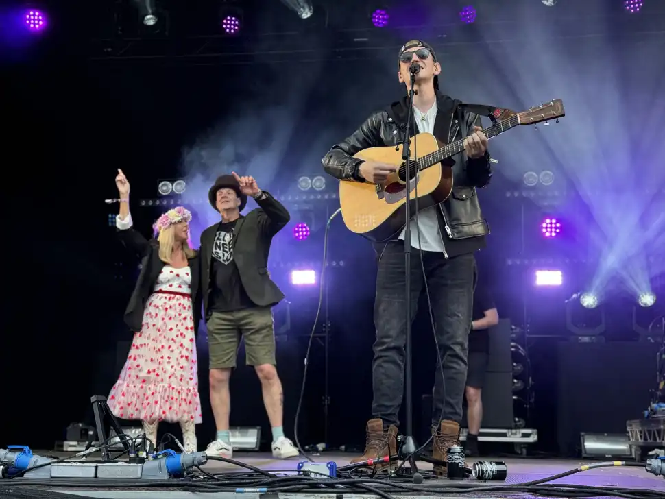 Nathan Evans playing on the Garden Stage supported by band members of Saint Phnx